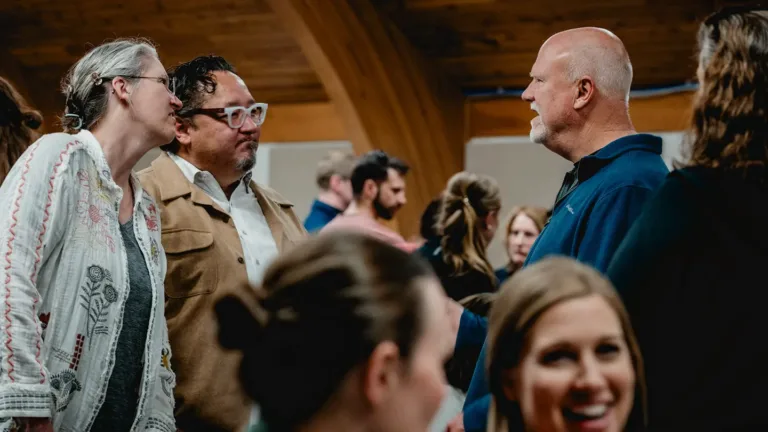 People greeting each other during a service at Harvest RIdge Church